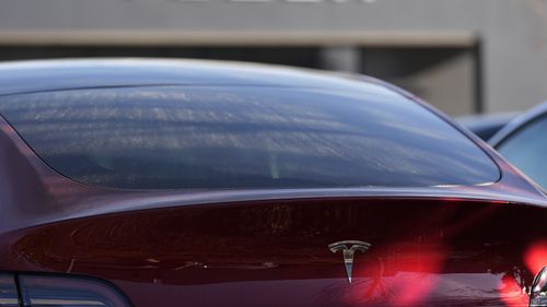 FILE - A Tesla model Y and other Telsla vehicles sit at a dealership, Wednesday, March 19, 2025, in Kennesaw, Ga. (AP Photo/Mike Stewart, File)
