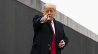 US President Donald Trump points to a member of the audience.