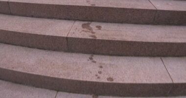 Two men allegedly sprayed an unknown oil-based substance on the Anzac memorial