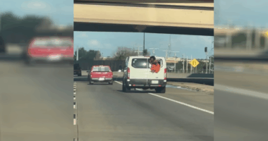 Video: Inmate hangs out of van on Oklahoma highway