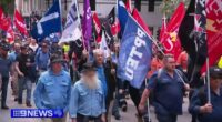 Workers march on parliament amid Brisbane Olympics warning