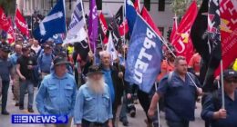 Workers march on parliament amid Brisbane Olympics warning