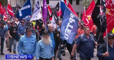 Workers march on parliament amid Brisbane Olympics warning