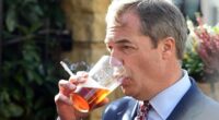 Controversial UK politician Nigel Farage slams Australia's smoking bans for causing rise of criminal gangs as he puffs on a dart outside a pub