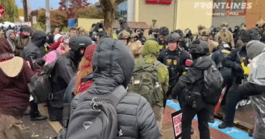 GIF of agents clashing with protesters in Portland at an ICE facility