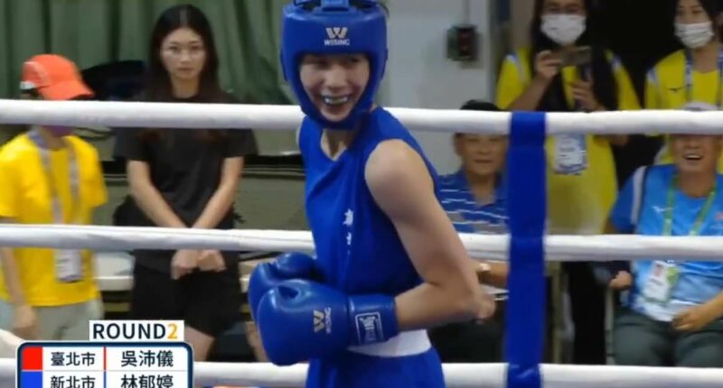 Astonishing moment gender-row boxer smirks as opponent throws in towel