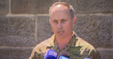 Brigadier Ben McLennan speaking at a press conference in his uniform.