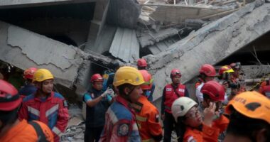 Children found alive beneath rubble of collapsed Indonesian school