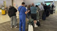Passengers seek updates on their delayed flight at Louis Armstrong New Orleans International Airport, Aug. 6, 2025, in Kenner, La. (Jack Brooks, Associated Press)