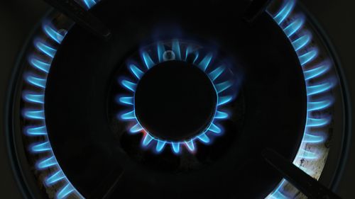 A gas flame burns on a gas stove top on August 19, 2022.