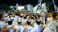 Israel has received a coffin carrying the body of a deceased hostage, the prime minister's office said in a statement late Friday. In this October 14 photo, people celebrated in Tel Aviv's Hostages Square after the announcement that bodies of four Israeli hostages would be released.