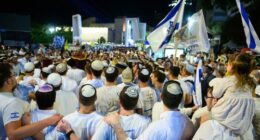 Israel has received a coffin carrying the body of a deceased hostage, the prime minister's office said in a statement late Friday. In this October 14 photo, people celebrated in Tel Aviv's Hostages Square after the announcement that bodies of four Israeli hostages would be released.