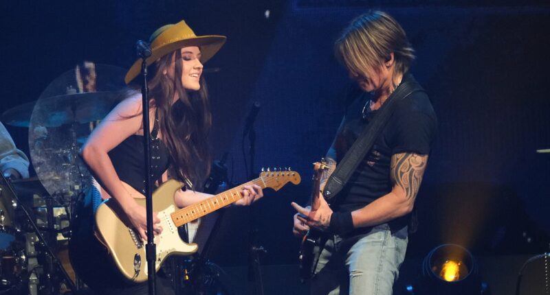 Keith Urban, 57, points to Maggie Baugh, 25, singing 'love' lyric