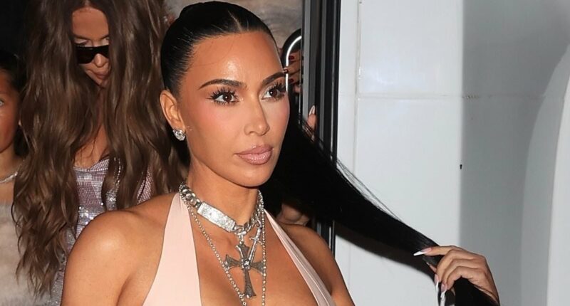 Kim Kardashian nearly spills out of VERY low-cut latex gown