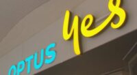 A low angle shot of the front of an Optus store sign.
