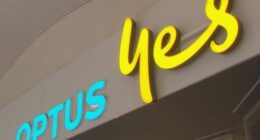 A low angle shot of the front of an Optus store sign.