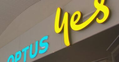 A low angle shot of the front of an Optus store sign.