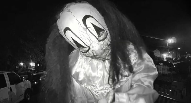 Moment trio in Halloween masks taunt family on doorbell camera