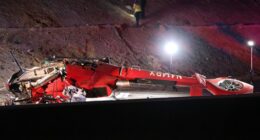 Motorists help lift crashed medical helicopter off pinned passenger