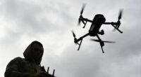 A Ukrainian serviceman operates a drone during a competition that simulates combat conditions