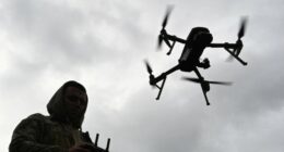 A Ukrainian serviceman operates a drone during a competition that simulates combat conditions