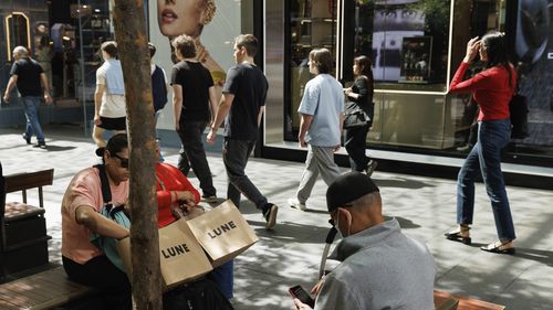 Shoppers sit down for a rest in Pitt St Mall in the Sydney CBD.