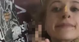 Pro-Palestinian supporter SPITS on poster of Israeli hostages