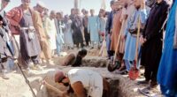 Locals dig graves for people killed in a cross-border airstrike by the Pakistani army in Afghanistan's eastern Paktika province, Saturday, Oct. 18, 2025. (AP Photo/Shafiqullah Mashaal)