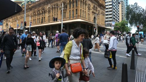 Pedestrians move along George Street on October 22, 2022 in Sydney, Australia.