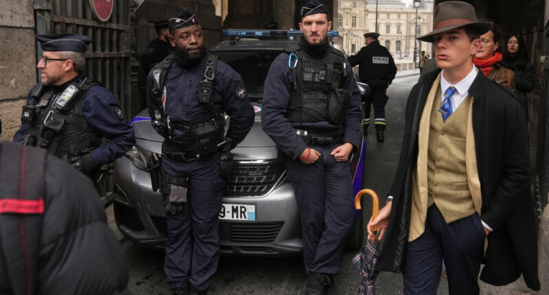 The Louvre detective? Mystery dapper 'detective' in AP photo after the Louvre heist creates social media buzz