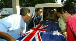 Three coffins containing Australian victims of the 2005 Bali bombings, draped in an Australian flag.