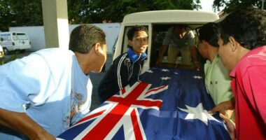 Three coffins containing Australian victims of the 2005 Bali bombings, draped in an Australian flag.