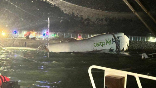 Two dead after cargo plane skids off runway into sea at one of Asia's busiest airports