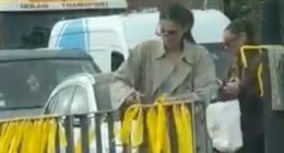 Two smirking women tear down yellow ribbons on October 7 anniversary