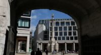 People walk near the London Stock Exchange in Paternoster Square, London