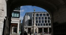 People walk near the London Stock Exchange in Paternoster Square, London