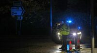 Police stand guard near the Huntingdon, England, train station in Cambridgeshire, after people were stabbed on a train, Saturday, Nov. 1, 2025. (Chris Radburn/PA via AP)