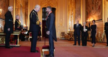 Bend a knee like Beckham: Soccer star is knighted by King Charles III