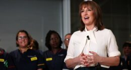 Rachel Reeves speaks in front of nurses, gesturing with her hands and smiling, during a visit to University College London Hospital.