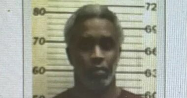 Diddy seen in first prison mugshot... and has now gone completely gray