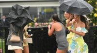 Young racegoers are seen in the rain during Champions Day at Flemington Racecourse.