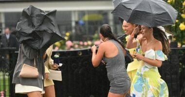 Young racegoers are seen in the rain during Champions Day at Flemington Racecourse.