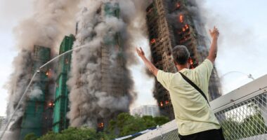 Fire tears through Hong Kong housing complex, killing at least 13 with others reported trapped