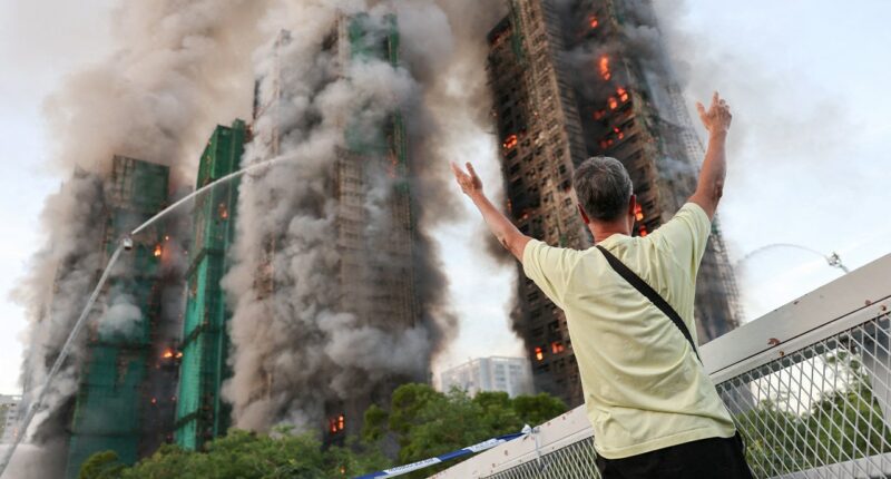 Fire tears through Hong Kong housing complex, killing at least 13 with others reported trapped