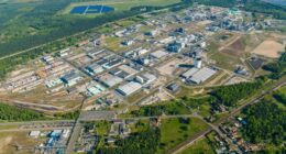 Aerial view of the Ineos industrial complex in Schwarzheide, Germany, showing large factory buildings, storage tanks and rail lines