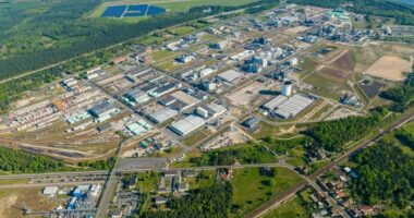 Aerial view of the Ineos industrial complex in Schwarzheide, Germany, showing large factory buildings, storage tanks and rail lines
