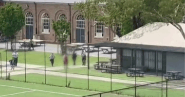 Police surrounding a student armed with a knife at North Sydney Boys High.