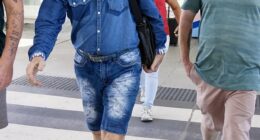 One could be forgiven for thinking Sir Cliff Richard was en route to the Australian jungle as he made his way across Brisbane Airport on Tuesday morning