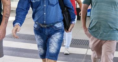 One could be forgiven for thinking Sir Cliff Richard was en route to the Australian jungle as he made his way across Brisbane Airport on Tuesday morning