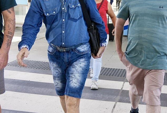 One could be forgiven for thinking Sir Cliff Richard was en route to the Australian jungle as he made his way across Brisbane Airport on Tuesday morning